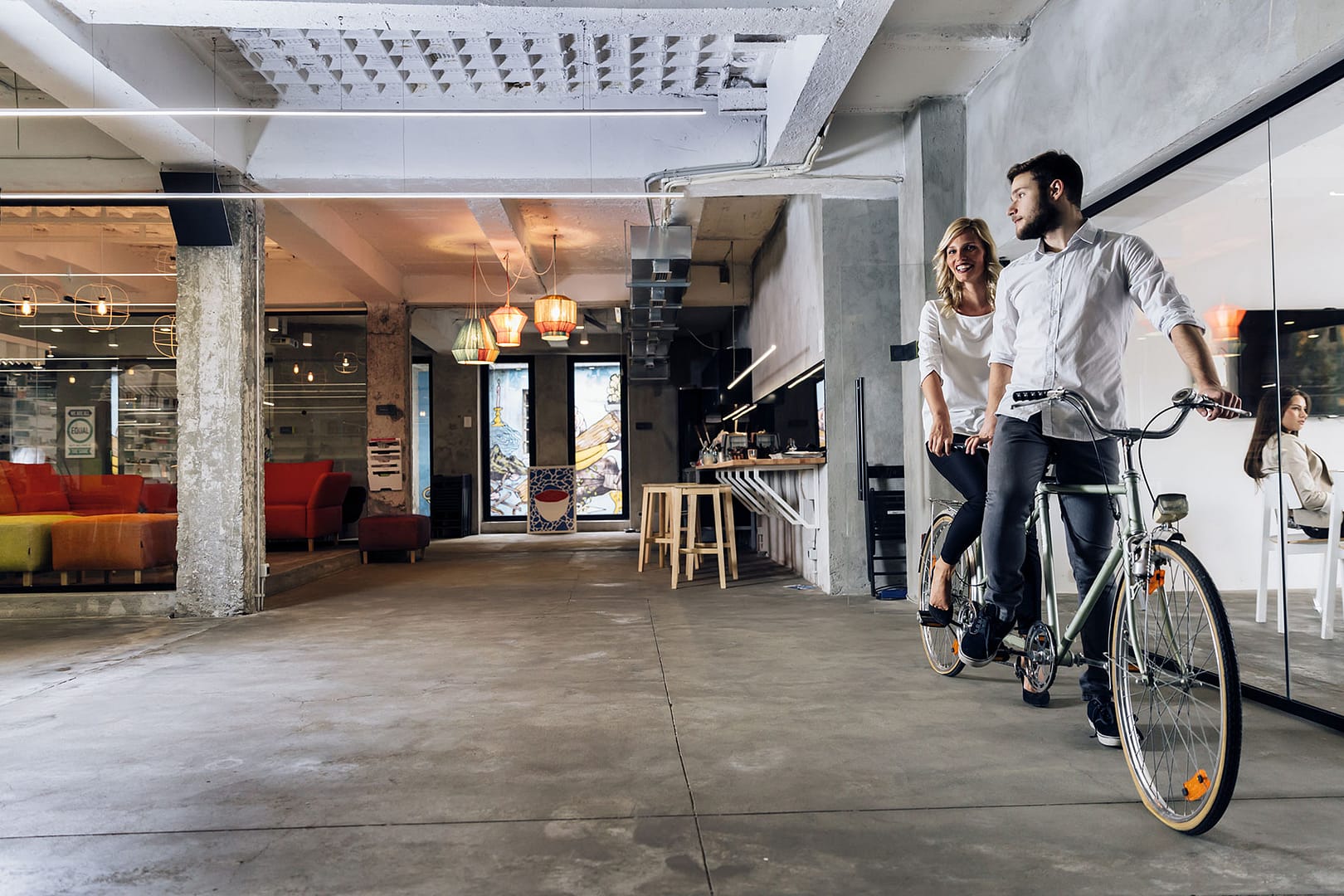 Man and woman with bicycle in office.