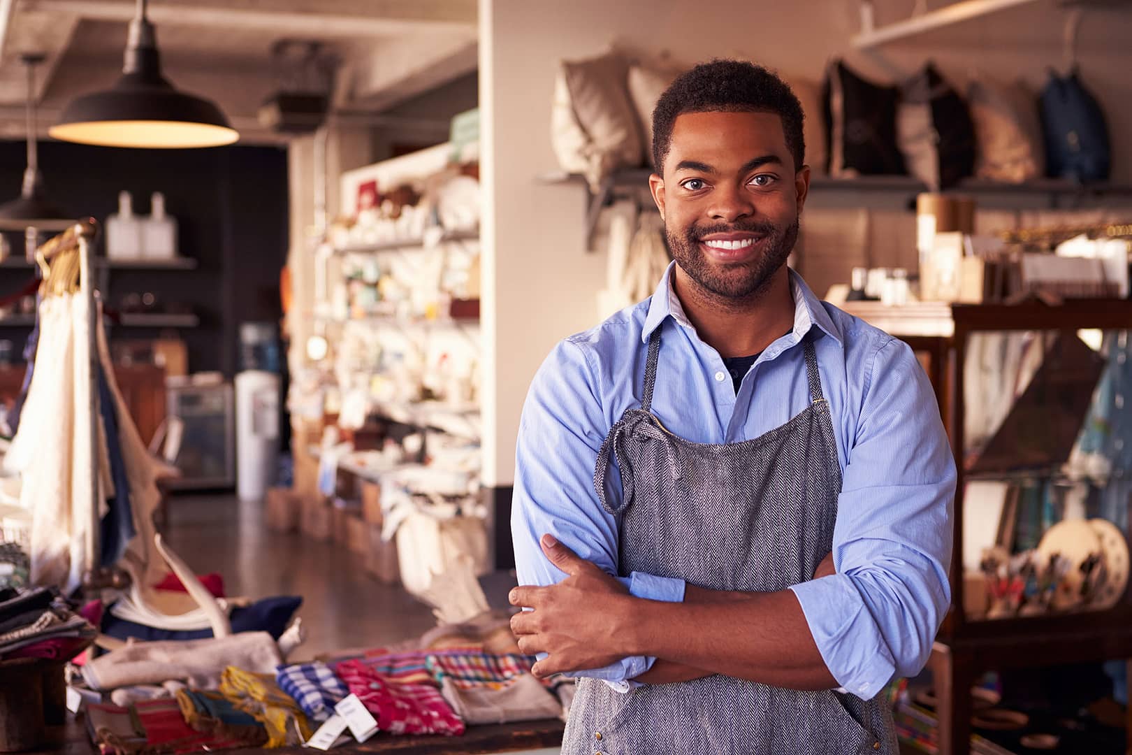 Store owner smiling in a fabric shop.